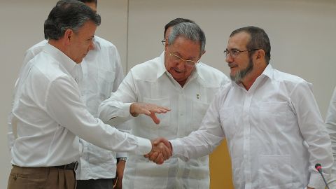 Colombian President Juan Manuel Santos, left, and FARC leader Timoleon Jimenez, right, in Havana.
