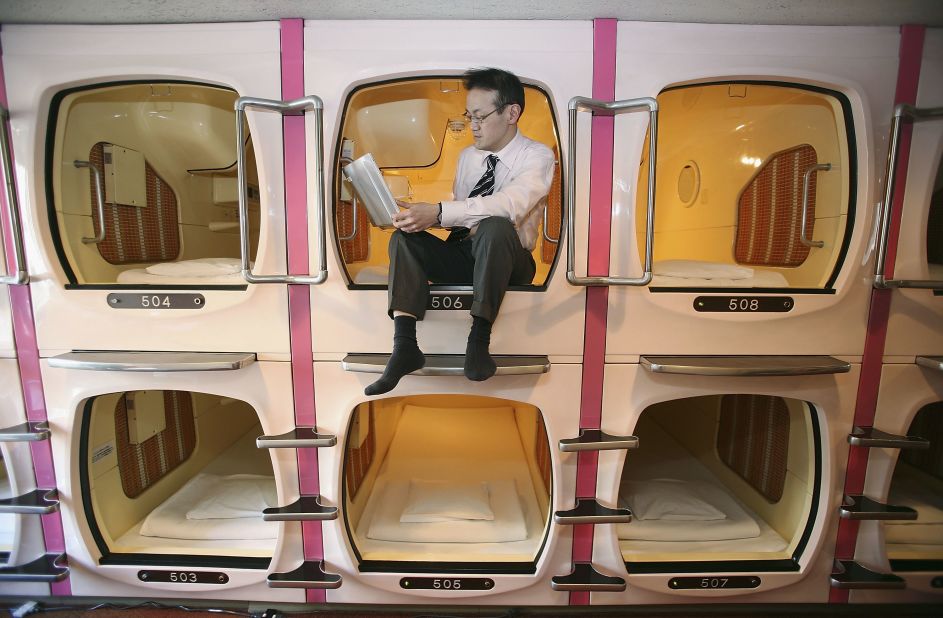A visitor relaxes in a sleeping module at Tokyo's Capsule Inn Akihabara, in 2007. The two-square-meter sleep modules are equipped with a TV, Radio and Wireless LAN.