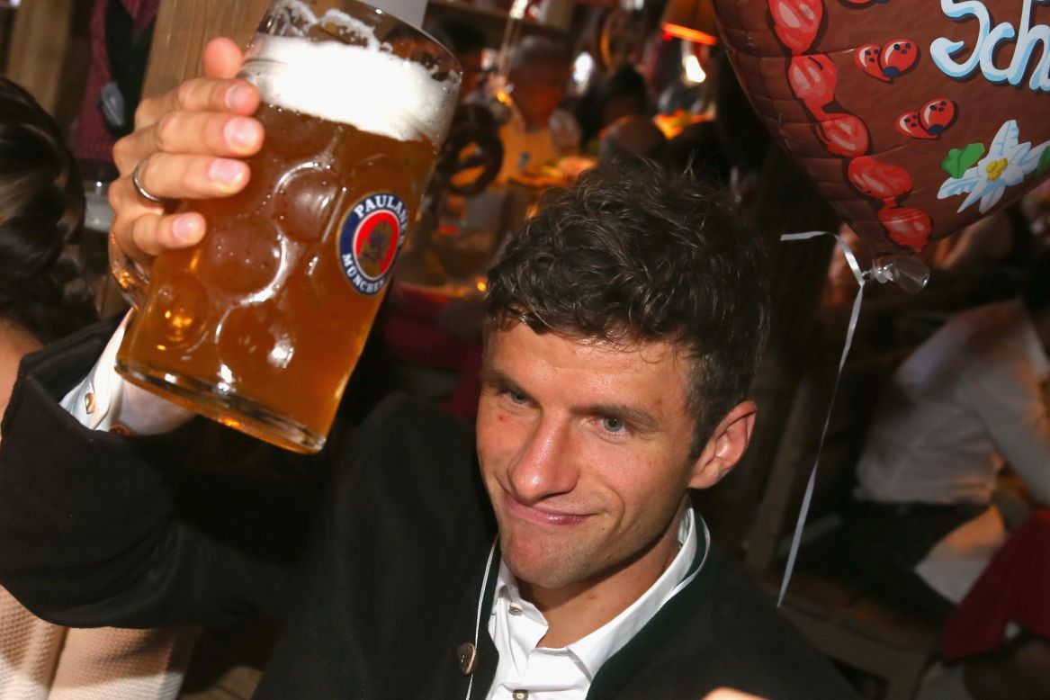 Bayern striker Thomas Muller enjoys a beer at the club's annual visit to Oktoberfest. The Reds recorded a 5-0 win over Dinamo Zagreb in the Champions League on Tuesday.