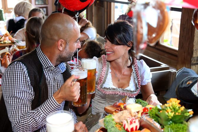 Prost! Guardiola and his wife Cristina Serra (R) raise a glass to one another. Let's hope the club's Spanish coach just had the one given he will need a clear head as the Bundesliga leaders prepare to face second place Borussia Dortmund on Sunday.