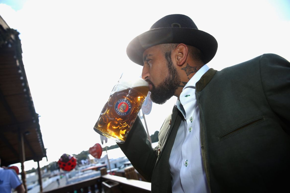 Chilean midfielder Arturo Vidal takes a swig from a stein in his traditional Bavarian outfit. 