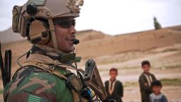 A U.S. Marine Special Operations Team member maintains security during a patrol with Afghan National Army Special Forces to escort a district governor to a school in Helmand province, Afghanistan, April 15, 2013.