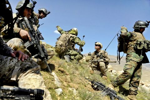 <strong>3. They can carry up to 100 pounds of gear in their rucksacks</strong><br /><br />In this photo, members of the 8th Commando Kandak and coalition Special Operations forces discuss troop movement during a firefight near in Daykundi province, Afghanistan, in 2012.