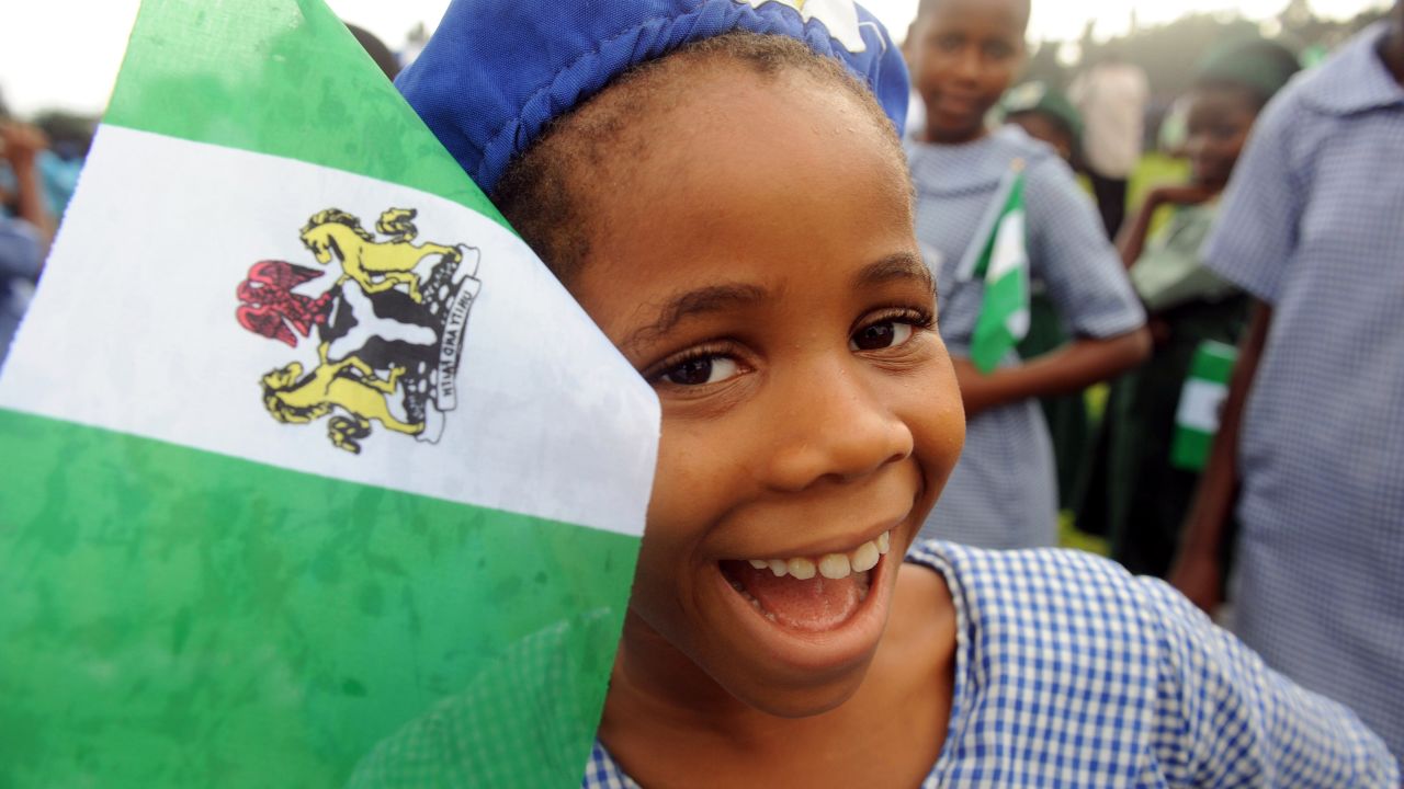 A Nigerian student smiles as she attends independence day celebrations in Lagos in October 1, 2013. Nigeria's president Goodluck Jonathan said he had formed a panel tasked with laying the ground for a national dialogue to tackle contentious issues such as religious tensions and the sharing of oil wealth during an address marking the 53rd anniversary of Nigeria's independence. AFP PHOTO/ PIUS UTOMI EKPEI        (Photo credit should read PIUS UTOMI EKPEI/AFP/Getty Images)