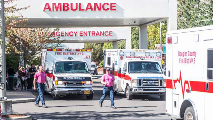 Paramedics return to their ambulances after delivering patients to Mercy Medical Center in Roseburg, Ore., following a deadly shooting at Umpqua Community College, in Roseburg, Thursday, Oct. 1, 2015. (Aaron Yost/Roseburg News-Review via AP)