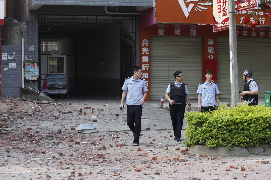 Police investigators inspect the area after a blast. The People's Daily, a national newspaper, said a man paid couriers to deliver the letter bombs across Liucheng.