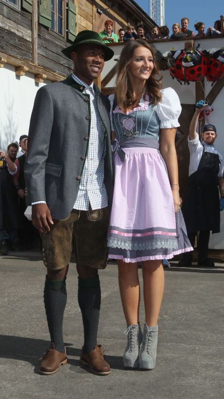 Katja Butylina is pictured with boyfriend David Alaba. Butylina's traditional outfit is offset by an altogether funkier pair of boots.