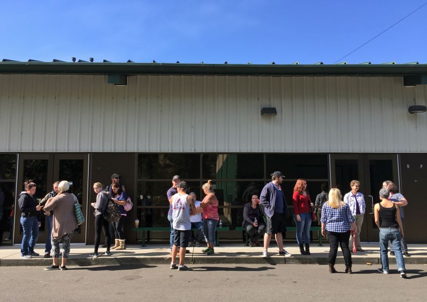 People wait for information at the fairgrounds on October 1.