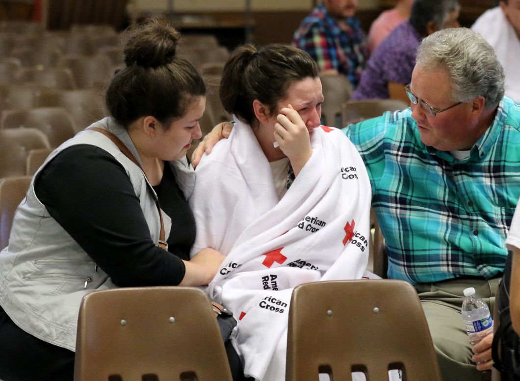 Hannah Miles, center, is reunited with her sister Hailey and father, Gary, on October 1.