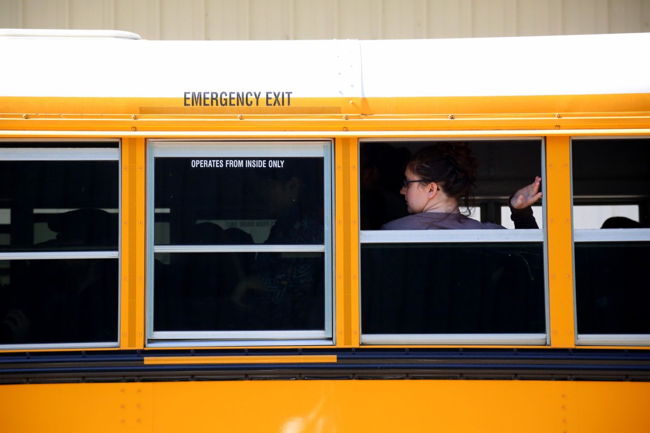A student waits to walk off a school bus at the fairgrounds on October 1.