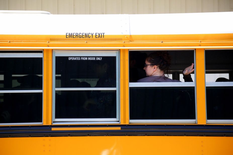 A student waits to walk off a school bus at the fairgrounds on October 1.