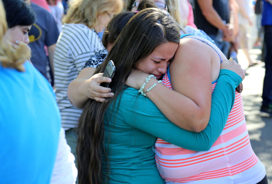A woman is comforted after the deadly shooting at Umpqua Community College in Roseburg, Oregon, on October 1. Douglas County Sheriff John Hanlin announced at a news conference that the shooter was dead.