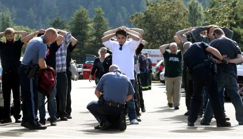 Police search students outside Umpqua Community College after <a href="http://www.cnn.com/2015/10/01/us/gallery/oregon-shooting-umpqua-community-college/index.html" target="_blank">a deadly shooting</a> at the school in Roseburg, Oregon, in October 2015. Nine people were killed and at least nine were injured, police said. The gunman, Chris Harper-Mercer, committed suicide after exchanging gunfire with officers, a sheriff said.