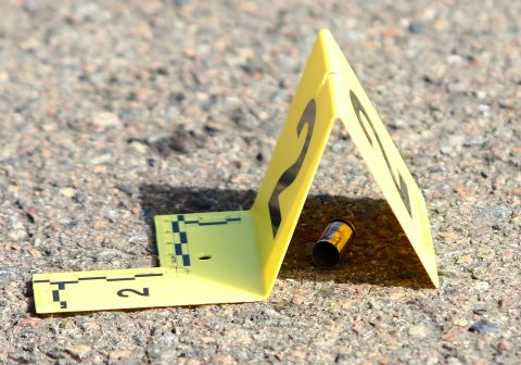 A bullet casing is marked at the scene of the shooting on October 1.