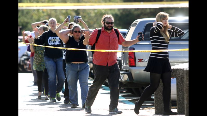 Students, staff and faculty from <a href="http://www.cnn.com/2015/10/01/us/oregon-college-shooting/index.html" target="_blank">Umpqua Community College</a> are led away from the school after a deadly shooting Thursday, October 1, in Roseburg, Oregon. Preliminary information indicated that nine people were killed and nine were wounded, police said. Douglas County Sheriff John Hanlin announced at a news conference that the shooter was dead.