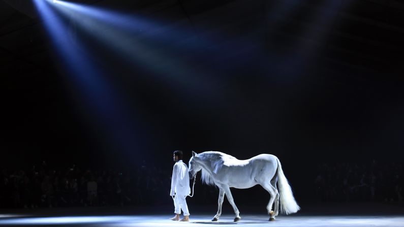 Fashion designer Simon Porte Jacquemus leads a horse on the catwalk during his label's fashion show in Paris on Tuesday, September 29.