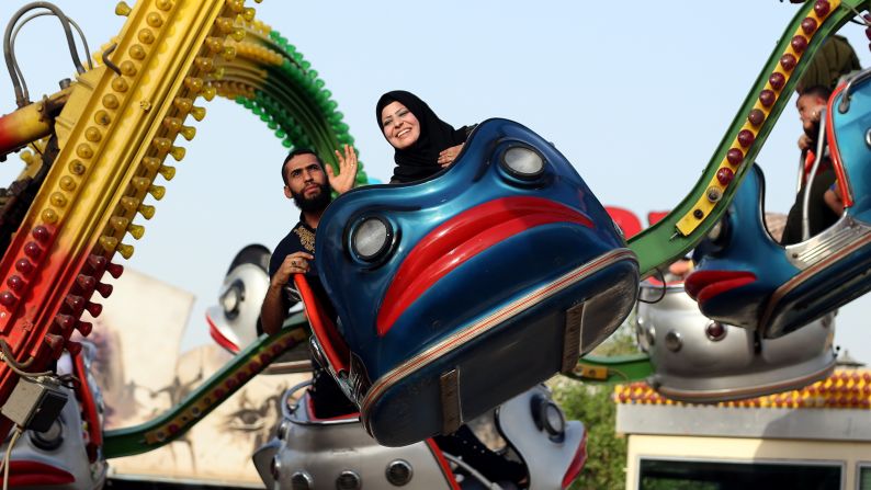 People in Baghdad, Iraq, enjoy an amusement ride during Eid al-Adha celebrations on Friday, September 25.