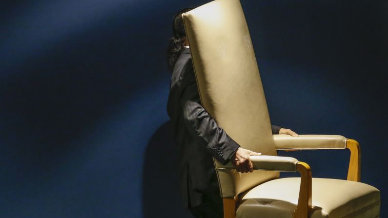 A man carries out a chair reserved for a head of state during the U.N. General Assembly in New York on Tuesday, September 29.