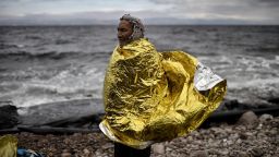 A man with a protective blanket wrapped around him stands on the shore of Lesbos, Greece, as refugees and migrants arrive after crossing the Aegean Sea from Turkey on Wednesday, September 30.