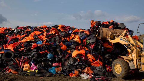 In September 2015, an excavator dumps life vests that were previously used by migrants on the Greek island of Lesbos.