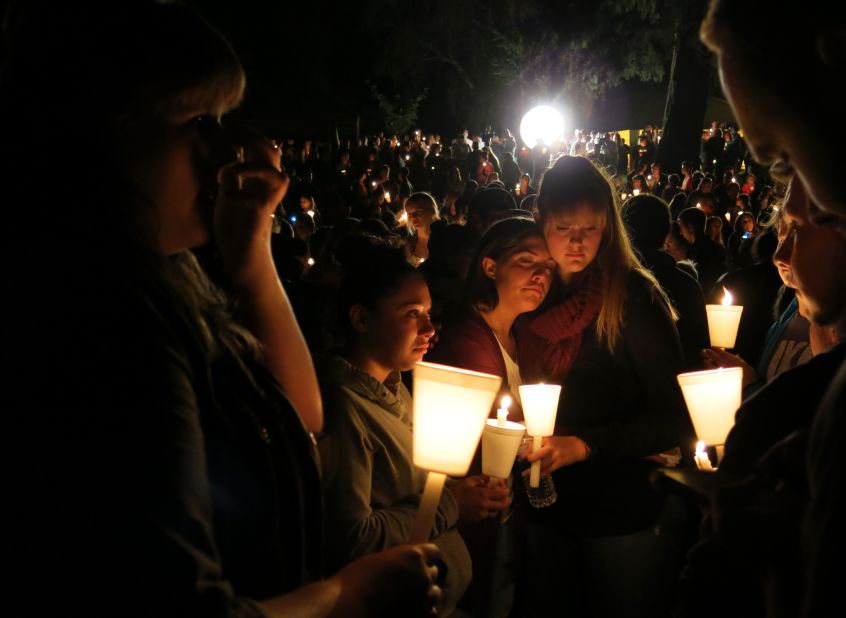 Community members attend a candlelight vigil at Stewart Park for those killed during a shooting at Umpqua Community College in Roseburg, Oregon, on Thursday, October 1. The massacre left nine people dead and nine wounded. The gunman also died.