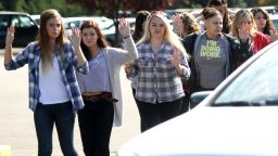 Students, staff and faculty are evacuated from Umpqua Community College in Roseburg, Oregon on October 1, 2015, after a deadly shooting.
