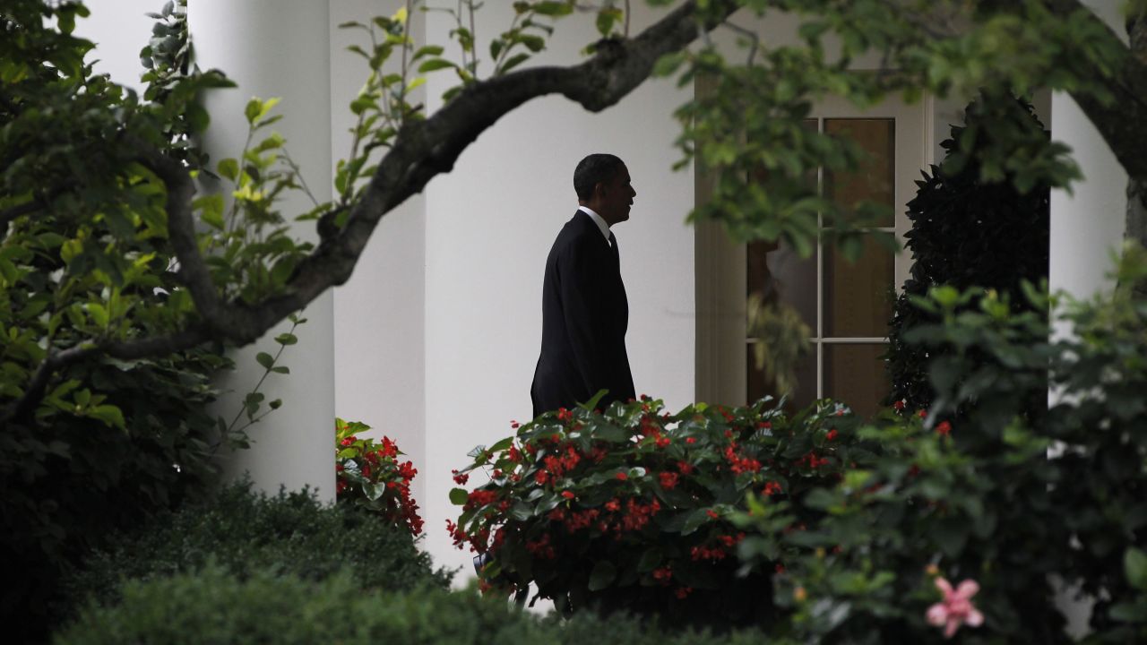 Obama walks back to the Oval Office of the White House in July 2012. Obama cut short a campaign stop in Florida in the aftermath of the mass shooting at a movie theater in Aurora, Colorado. Twelve moviegoers were killed and 70 were injured by convicted shooter James E. Holmes.