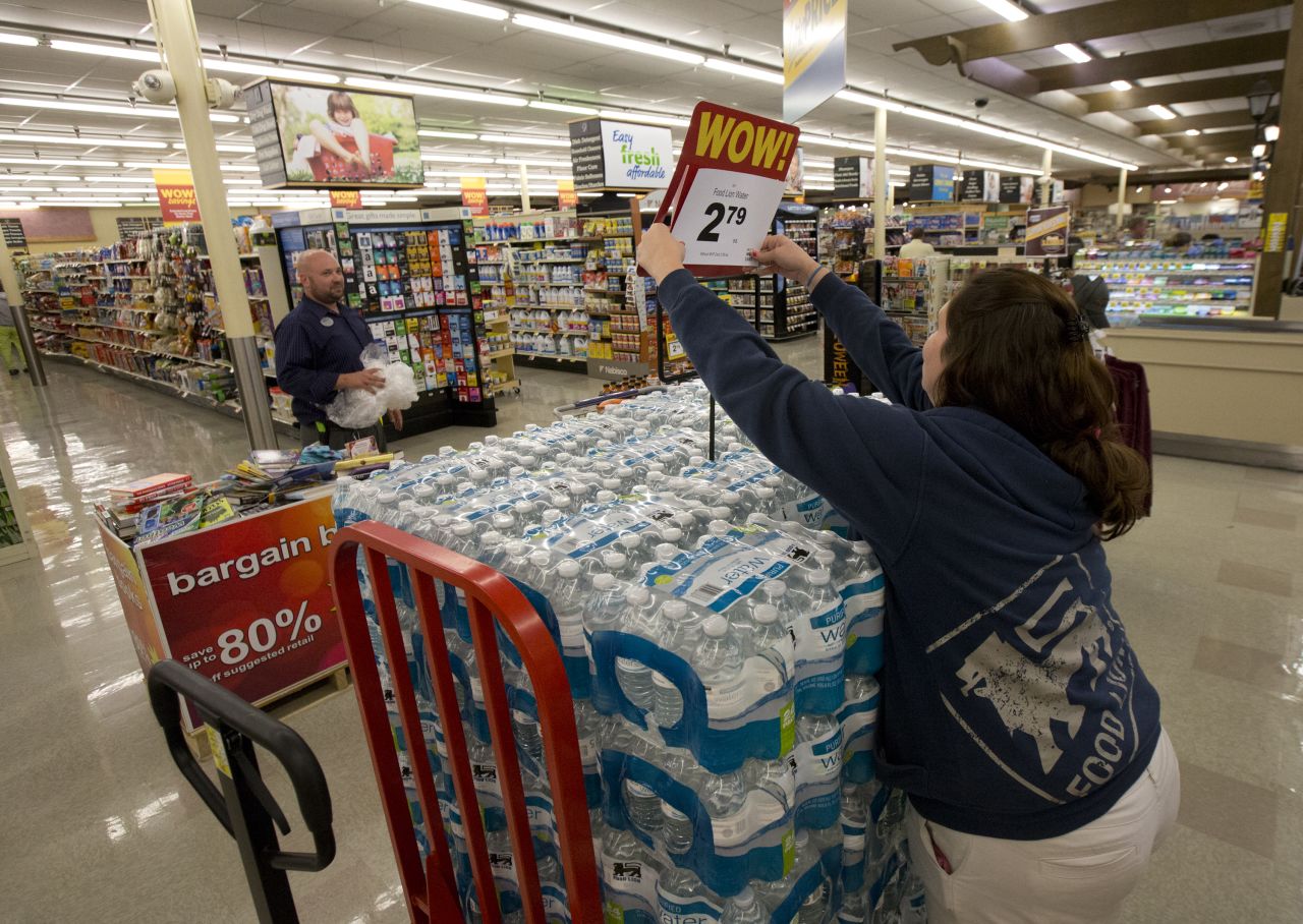 A supermarket worker in Newport News, Virginia, readies cases of bottled water on October 1.