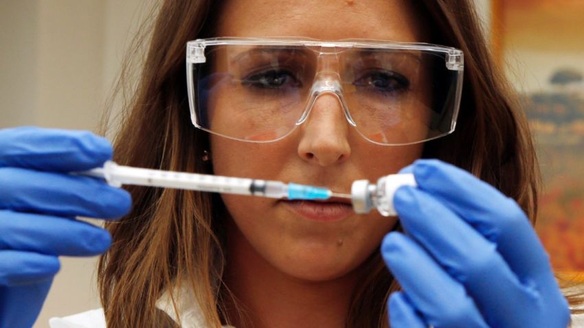 LONDON - ENGLAND - SEPTEMBER 17: Dr Felicity Hartnell, who is a clinical research fellow at Oxford University, holds the vile of the ebola vaccine called Chimp Adenovirus type 3 (ChAd3) before the first healthy UK volunteer receives an ebola vaccine at the Oxford Vaccine Group Centre for Clinical Vaccinology and Tropical Medicine (CCVTM) on September 17, 2014 in Oxford, England. (Photo by Steve Parsons-WPA Pool/Getty Images)