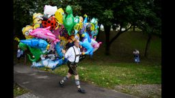 MUNICH, GERMANY - SEPTEMBER 19: A baloon-vendor in bavarian folk attire carries a bunch of helium baloons on the opening day of the 2015 Oktoberfest on September 19, 2015 in Munich, Germany. The 182nd Oktoberfest will be open to the public from September 19 through October 4 and will draw millions of visitors from across the globe in the world's largest beer fest. (Photo by Philipp Guelland/Getty Images)