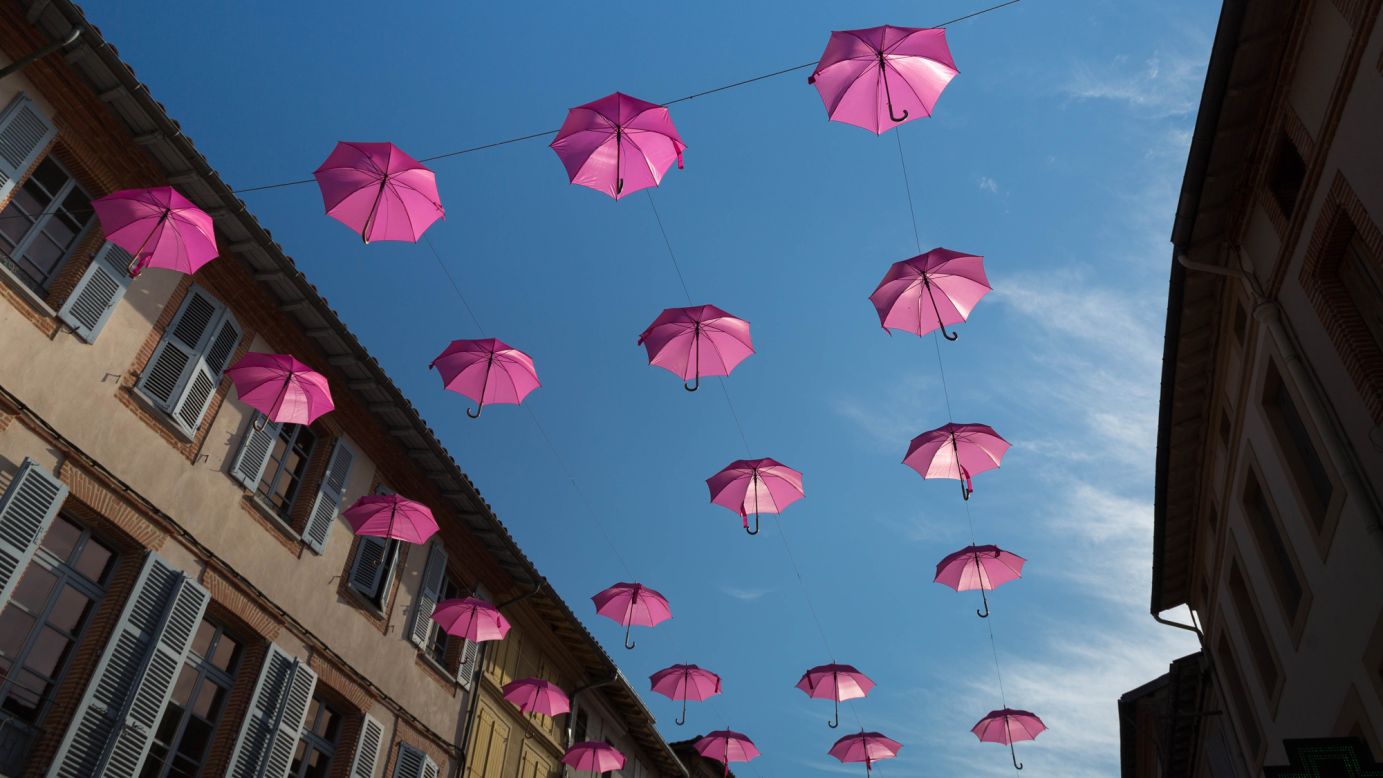 Pink umbrellas decorate a street to mark October's Breast Cancer Awareness Month. 