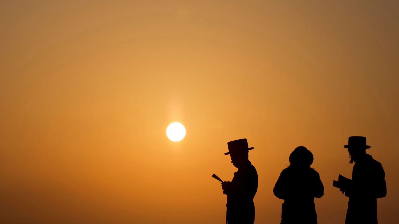 Ultra-Orthodox Jews pray on a hill overlooking the Mediterranean Sea as they participate in a Tashlich ceremony. Tashlich, which means "to cast away" in Hebrew, is a practice in which Jews go to a large flowing body of water and symbolically "throw away" their sins by throwing a piece of bread or similar food into the water.