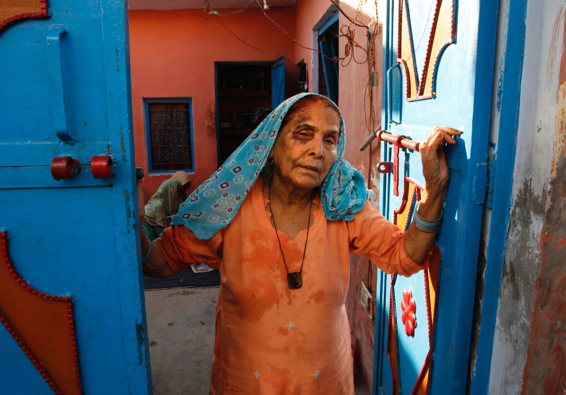 Asghari Begum, mother of the victim, stands by the entrance of her home in Bisara, a village near New Delhi, on September 30, 2015.