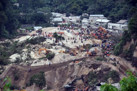 Rescue workers fan out around El Cambray village to search for survivors on October 2. 