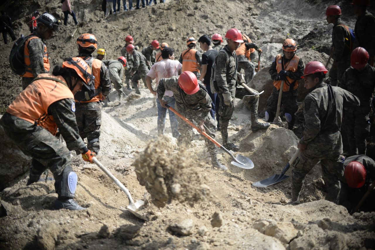 Army soldiers and rescuers search for victims on October 2. 