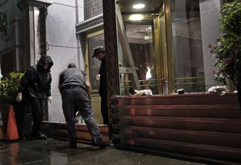 Workers install a flood barrier at the entrance to the Market Pavilion Hotel in downtown Charleston, South Carolina, on Friday, October 2. Parts of the South Carolina coast braced for likely flooding.