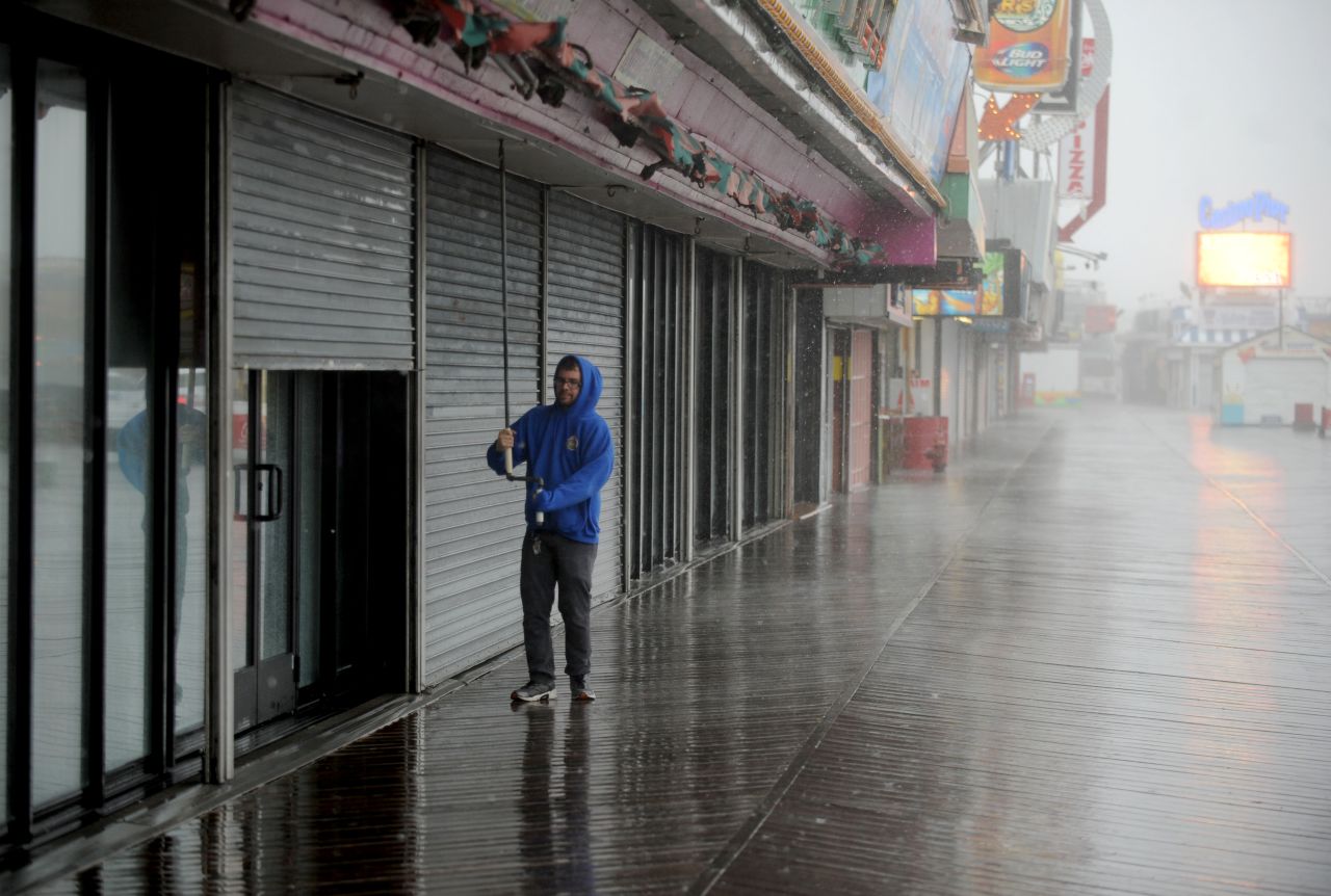 A man closes a storefront on October 2 in Seaside Heights, New Jersey.