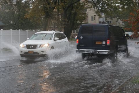 Cars negotiate flooded streets on October 2 in Midland Beach on Staten Island, New York. 