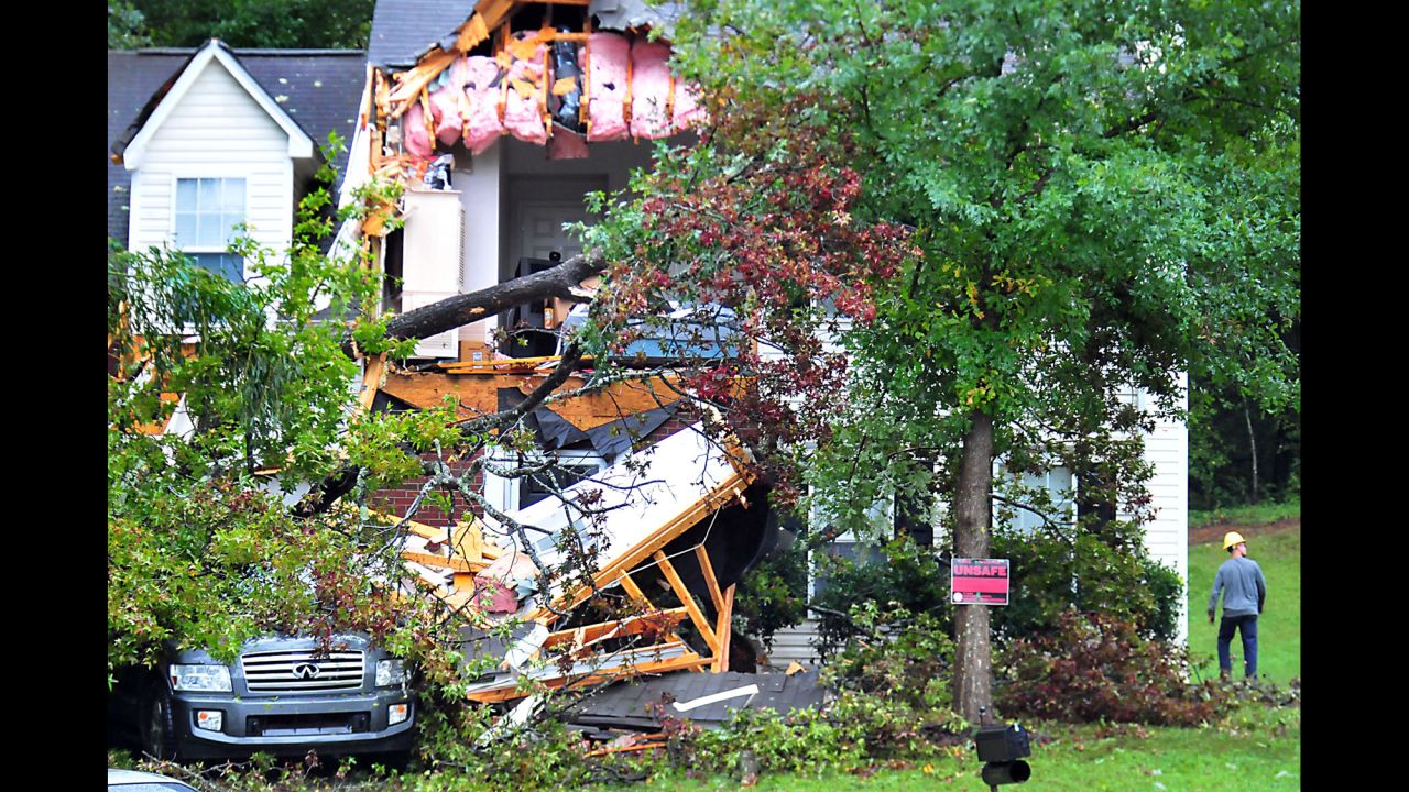 A utility worker examines the damage to a home Charlotte, North Carolina, on October 3.