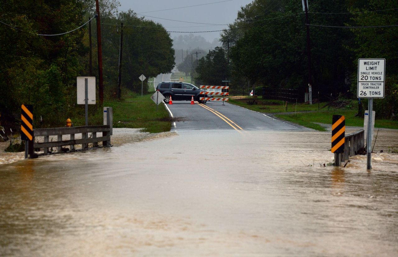 A motorist turns back as floodwater rises in Harrisburg, North Carolina, on October 3. 