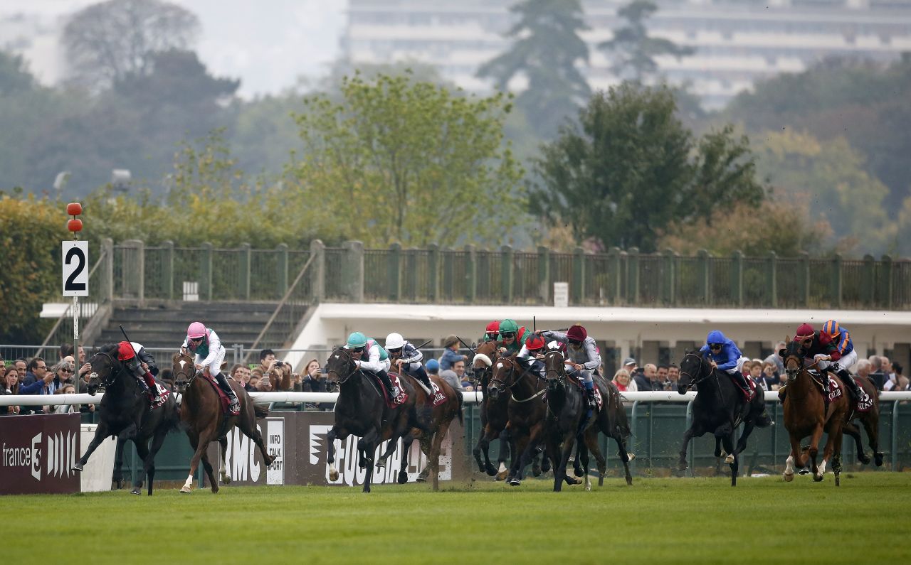 Dettori on the far left with Golden Horn drives to the front with two furlongs remaining of Europe's richest horse race 