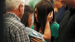 Lacey Scroggins, center right, is comforted during a church service at the New Beginnings Church of God, Sunday, October 4, in Roseburg, Ore. Scroggins is a survivor of the shooting at Umpqua Community College. 