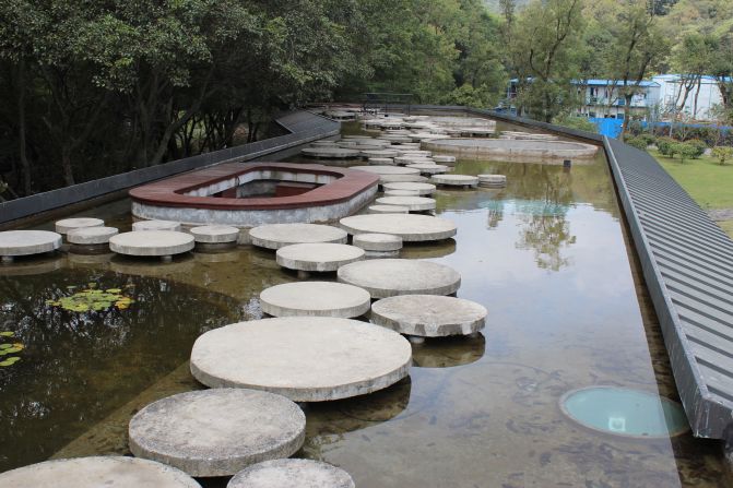 Concrete "pads" act as stepping stones guiding visitors to a hidden spiral stairwell that takes them down into the house of Pond Lily. 