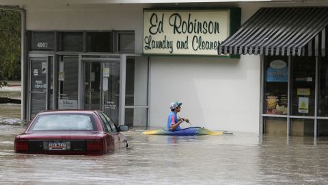 A man paddles up to a flooded store in Columbia, South Carolina, on October 4.