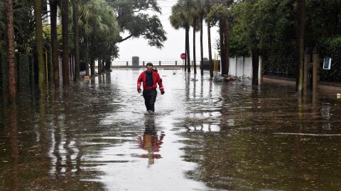 A firefighter walks down a flooded street in downtown Charleston, South Carolina, on October 4.