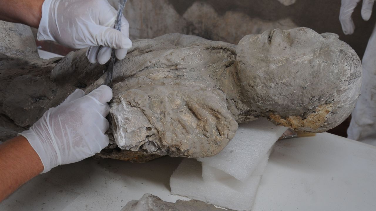 A restorer works on a petrified victim of the eruption of Vesuvius volcano in 79 BC, as part of the restoration work and the study of 86 casts in the laboratory of Pompeii Archaeological Site, on May 20, 2015 in Pompeii.   AFP PHOTO / MARIO LAPORTA        (Photo credit should read MARIO LAPORTA/AFP/Getty Images)