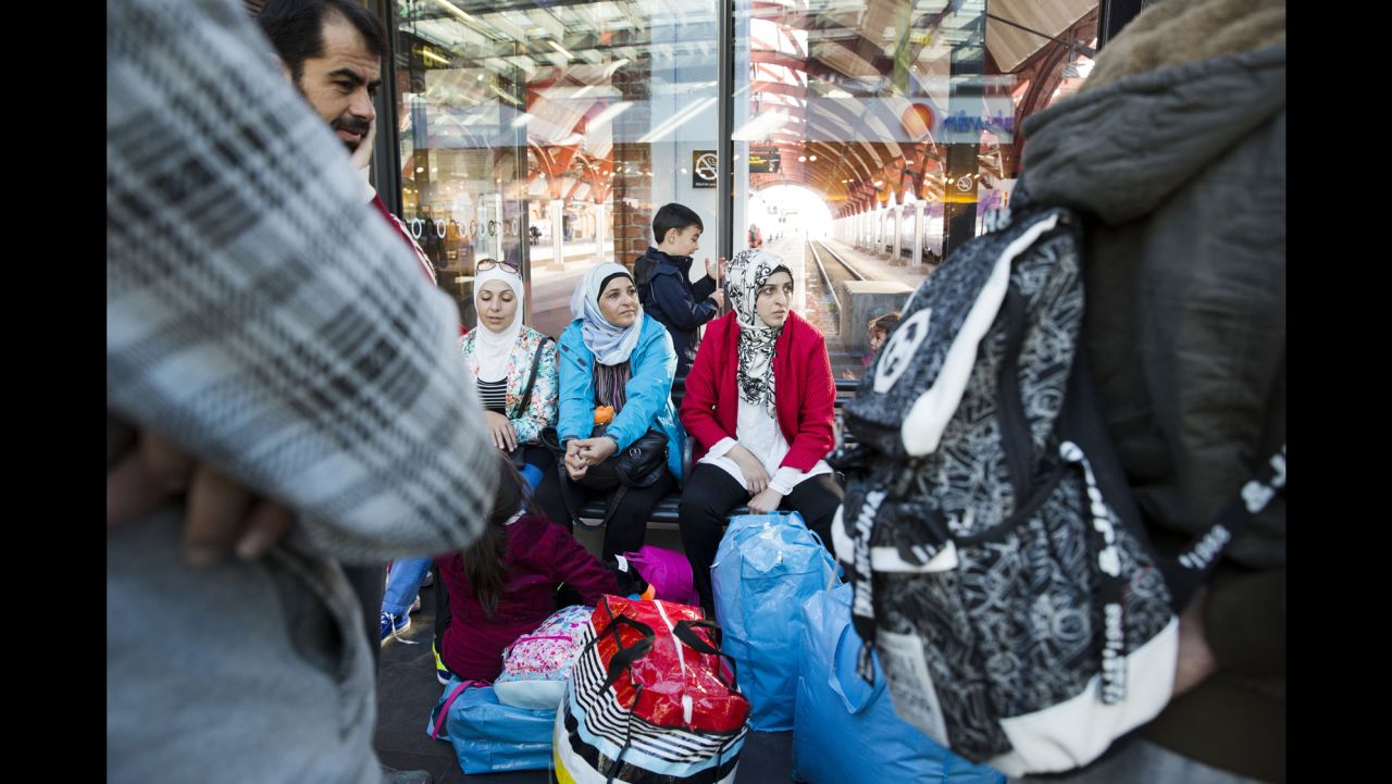 Refugees from Syria sit at the railway station in Malmo, Sweden, on September 7.