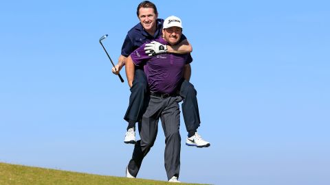 Pro golfer Graeme McDowell gives a piggyback ride to his amateur playing partner, former jockey Tony McCoy, while practicing Wednesday, September 30, for the Alfred Dunhill Links Championship in St. Andrews, Scotland. Both men are from Northern Ireland.