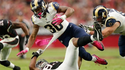 St. Louis Rams running back Todd Gurley is tripped up by Arizona's Calais Campbell during an NFL game in Glendale, Arizona, on Sunday, October 4. The rookie had 146 rushing yards for the Rams, who won 24-22.