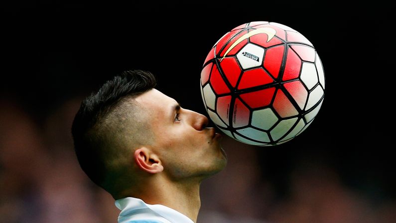 Manchester City striker Sergio Aguero kisses the ball Saturday, October 3, while celebrating one of his five goals against Newcastle in Manchester, England.